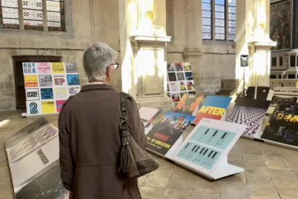 Une personne devant des pochettes d'albums de musique