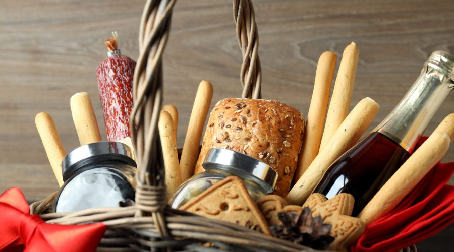 Concept of gift with Christmas basket on wooden background